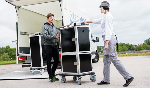 People loading a ScanBox cart into a truck
