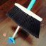 Close-up of the SweepEasy® Broom’s built-in retractable scraper, ideal for removing tough debris like gum and stickers.