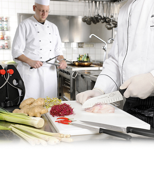 Chefs working in a professional kitchen with culinary tools