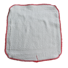 Three white wash cloths with red and green trim, neatly folded and stacked on top of each other.