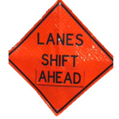 An orange sign with black lettering indicating upcoming lane shift.